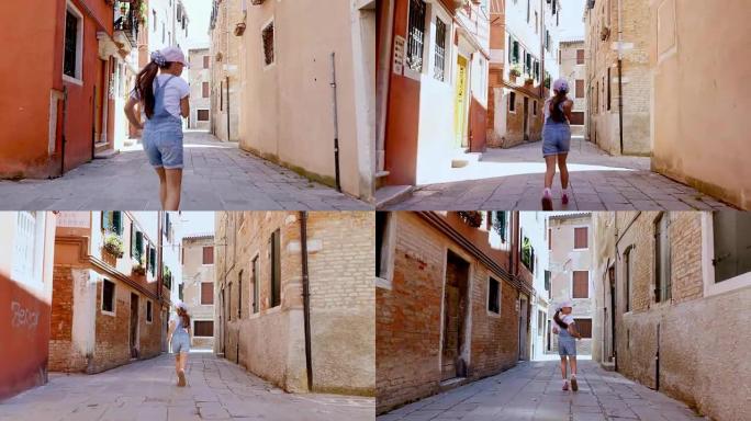 意大利威尼斯-2018年7月7日: 沿着威尼斯的一条狭窄街道，在老房子之间，一个十几岁的女孩，一个孩