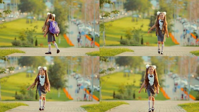 一所小学的小女孩在秋天的公园里散步