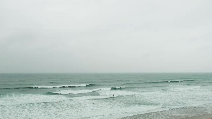 6月阴天，纽基菲斯特拉尔海滩的冲浪者。
