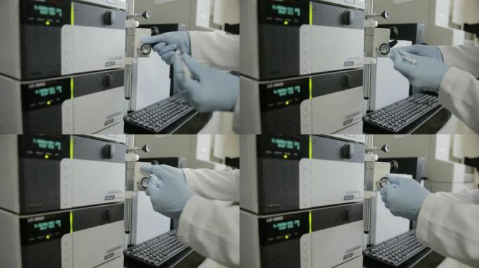 一名研究人员在大学遗传实验室检查HPLC的手持照片