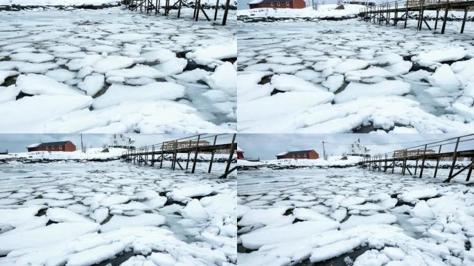 海面变成冰，雪开裂漂浮在海岸线上