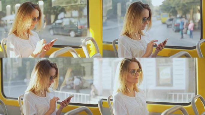 一个美丽的女孩在电车上听音乐并在智能手机上使用应用程序