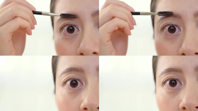 女性用眉胶修眉毛。