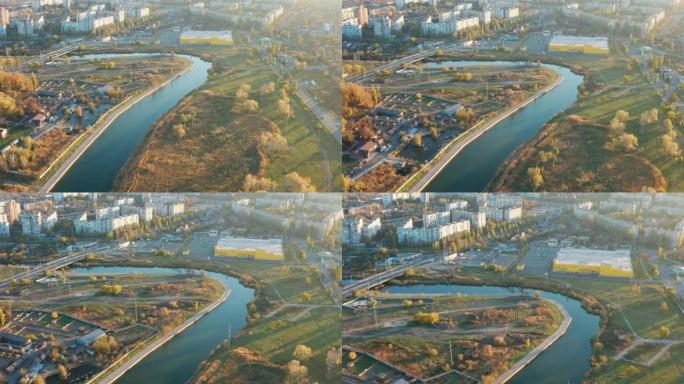 日落时城市中的河流。鸟瞰图