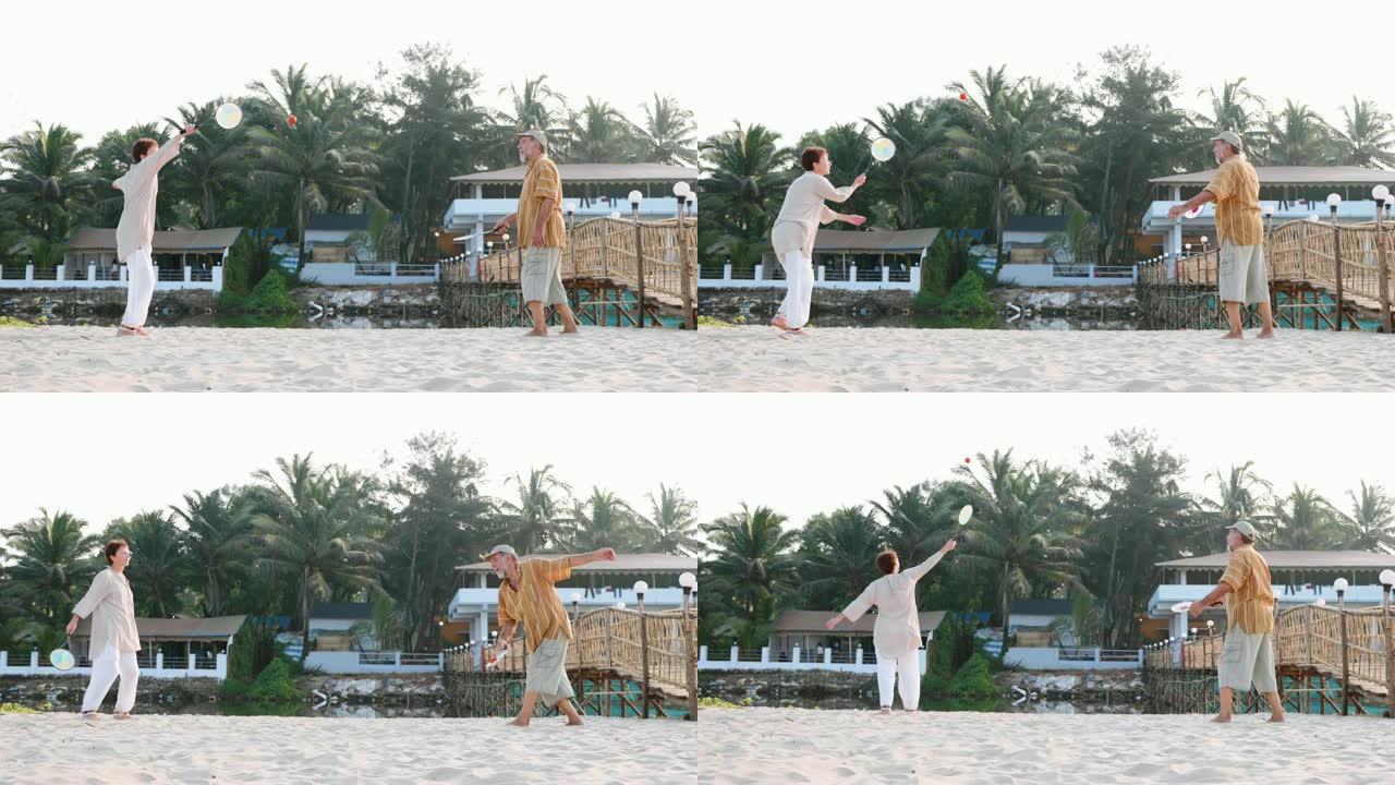 活跃的高级夫妇在海滩上慢动作打太极拳。