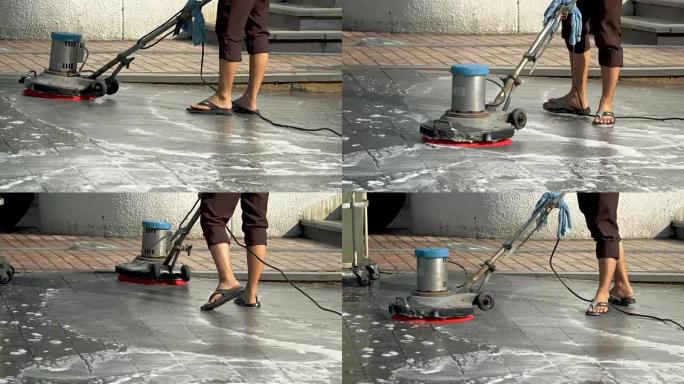 工人清洁砂洗外部走道使用抛光机和化学或酸