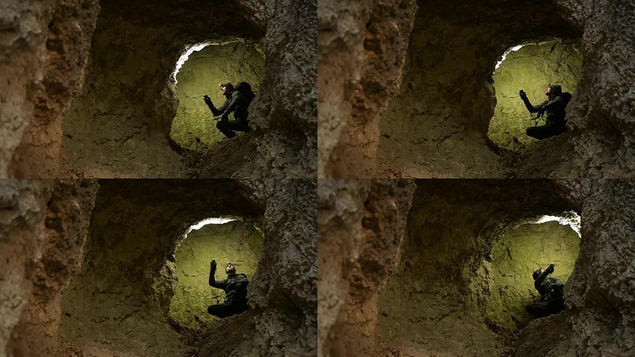 高加索洞穴探险家用手电筒照亮地层岩石。地质研究探险