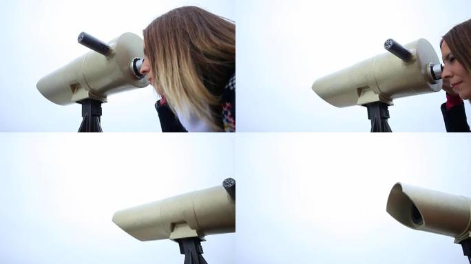 女人用双筒望远镜看。带电动滑块的全高清。