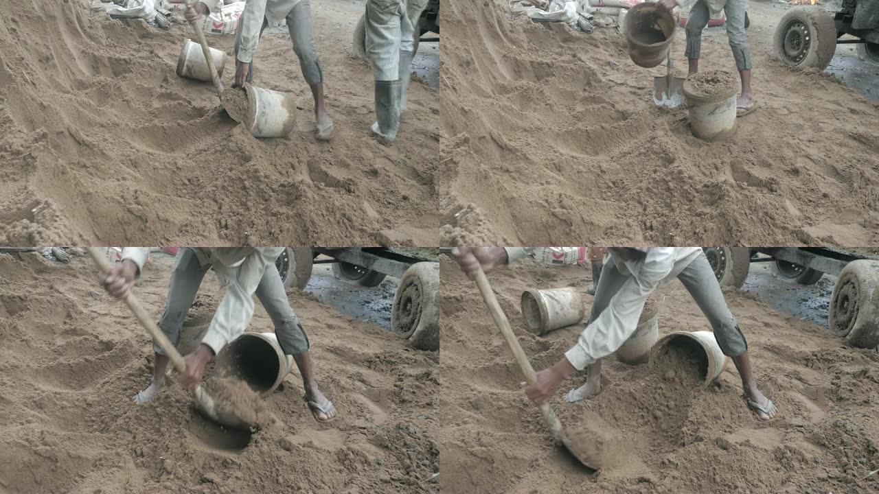用铲子将沙子放入桶中 (特写)
