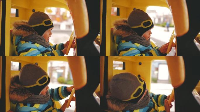 这个男孩戴着头盔在旋转木马上骑玩具车