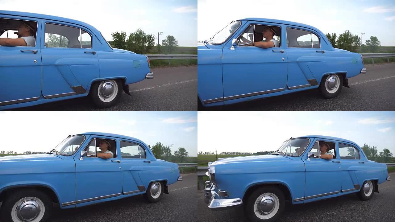 夏季在高速公路上行驶的老车。年轻夫妇开着老式汽车在乡间小路上行驶。复古汽车之旅。暑假或假期的概念。慢
