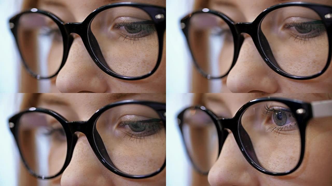 戴眼镜的女人在电脑上工作