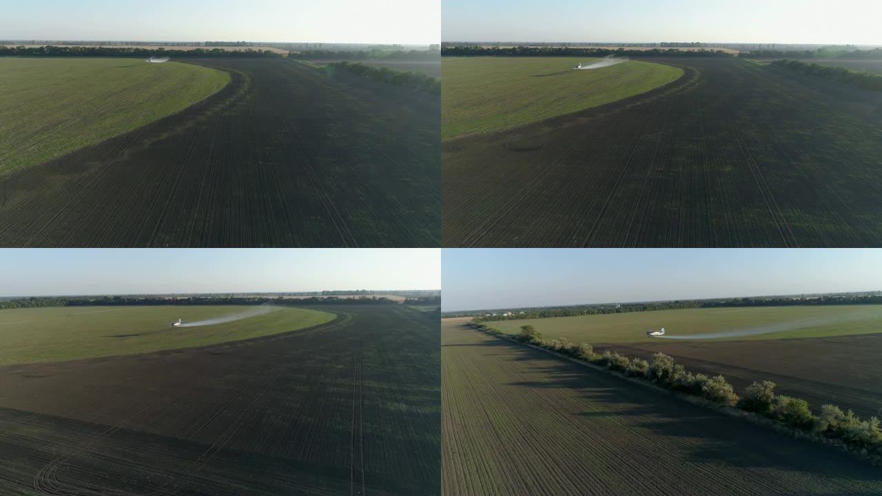 农业，双翼飞机用小麦飞过田野，并在老式推进飞机的鸟瞰图中飞溅化学物质以防止害虫