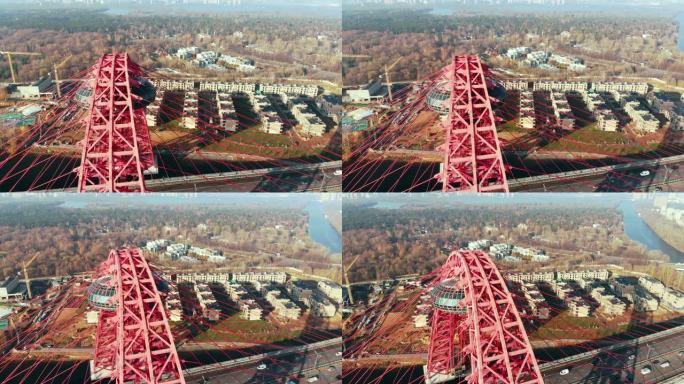 标志性地标的鸟瞰图是横跨莫斯科莫斯科河的风景如画的桥梁。白天，汽车在红色斜拉桥上行驶。4K。