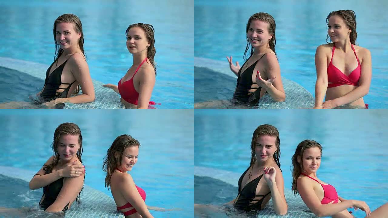 两个女朋友在游泳池里笑