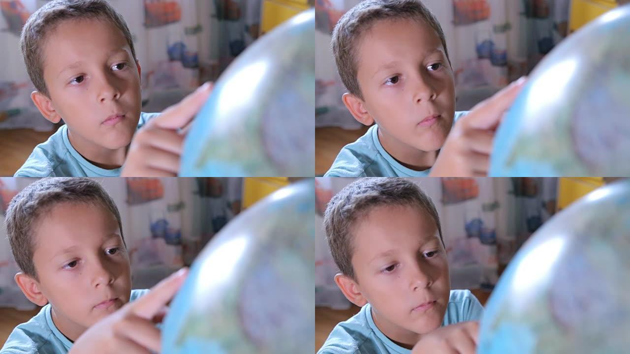 男孩用手指看着地球仪
