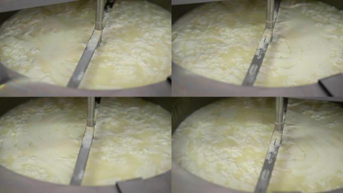 奶酪制作过程。用于混合奶酪成分的巨大钢桶