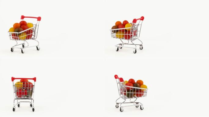 半帧。超市手推车装满了五彩樱桃番茄，上面堆满了水滴。在转盘上旋转。孤立在白色背景上。特写。宏观。