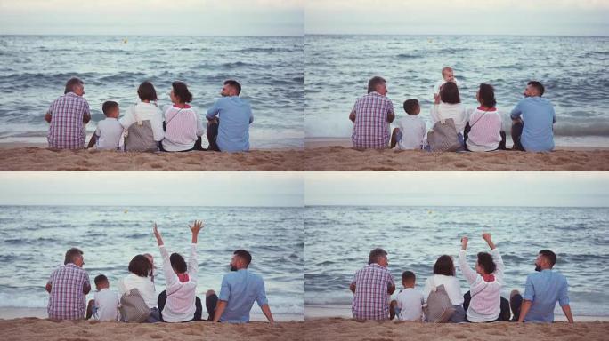 坐在海滩上欣赏海景的友好大家庭