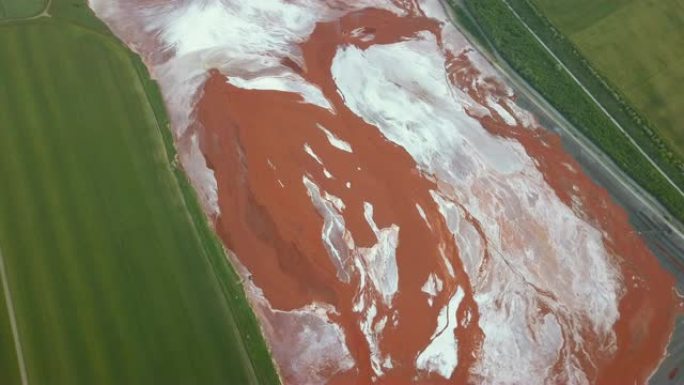 充满红色有毒污泥的水库的鸟瞰图