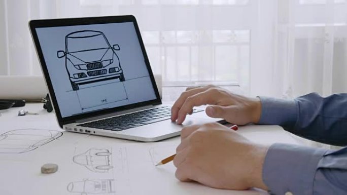 工程师使用他的笔记本电脑进行汽车设计草图