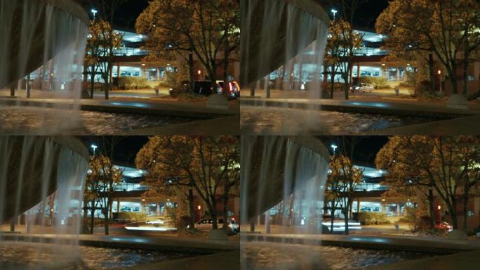 公园喷泉水上夜间繁忙的城市行动