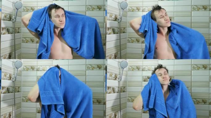 男子在浴室洗澡后用毛巾擦干