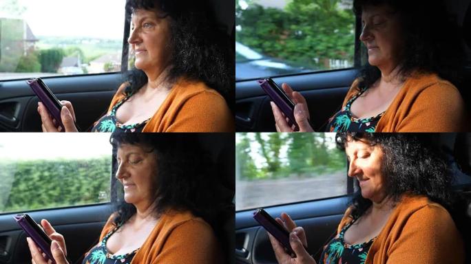 女人在行驶中的汽车里玩手机