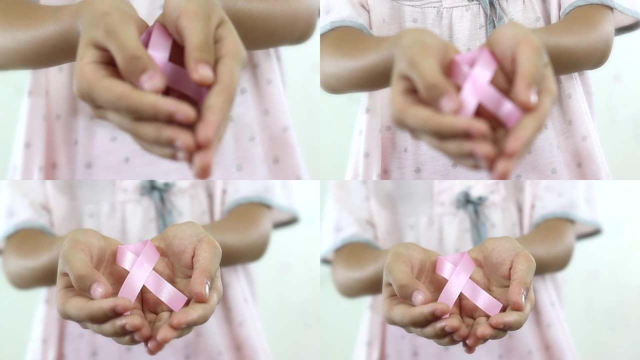 带粉色丝带的女孩。癌症意识概念。