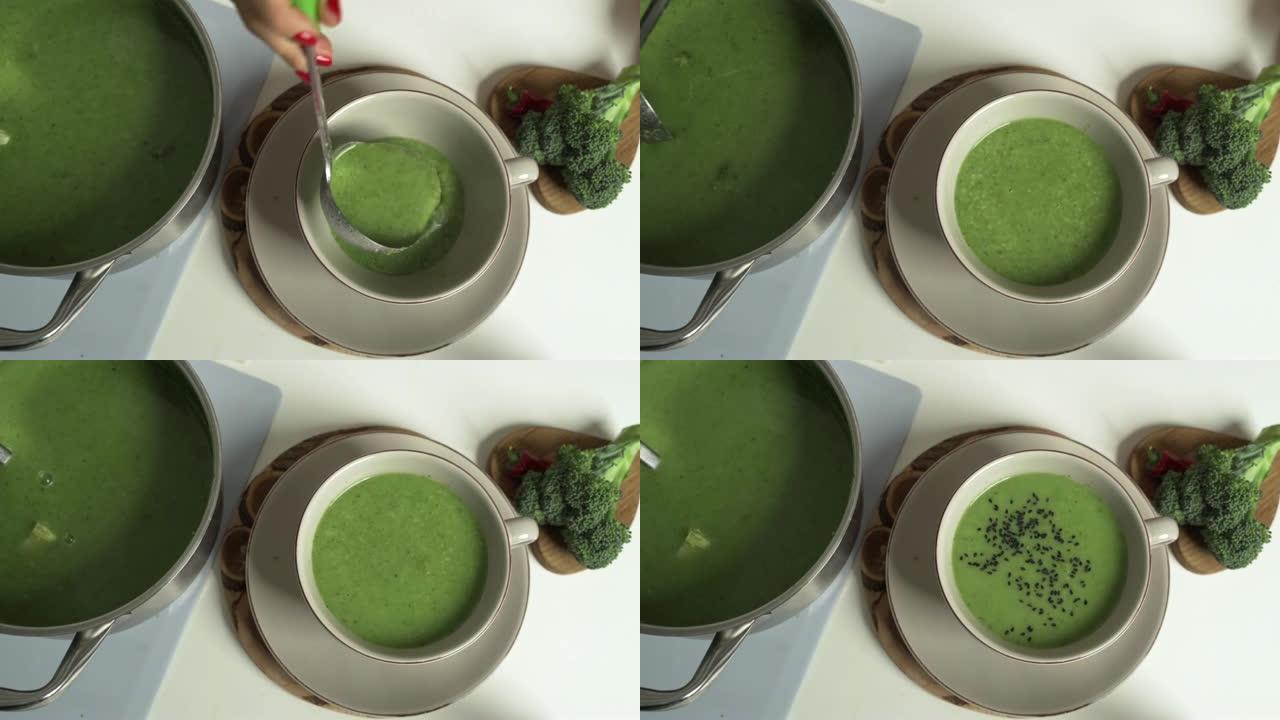 食物、烹饪和健康饮食概念 -- 蔬菜绿色罗马奶油汤放在碗里，芝麻菜和勺子放在厨房桌子上