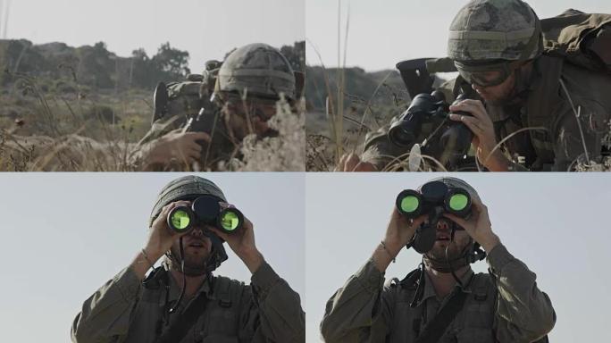 一名以色列士兵用双筒望远镜观察敌人