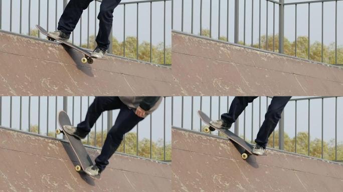 溜冰者在斜坡半径的边缘做特技摇滚站立，特写，慢动作