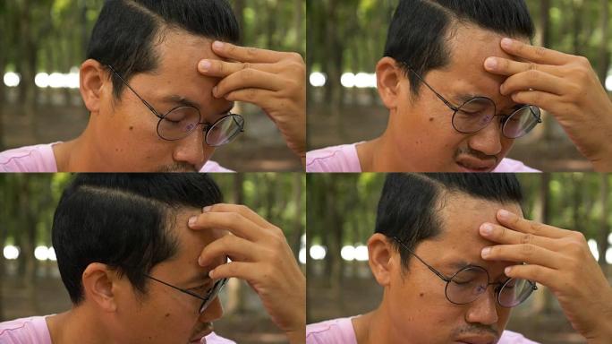 一个年轻的亚洲男人的肖像，戴着黑色眼镜的有吸引力的生活方式男人看起来很严肃。