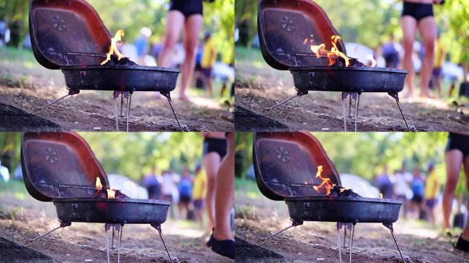 夏季周末烧烤。烤架着火了。烧烤架上发光的木炭和火焰。食物、人和假期概念。4K (UHD