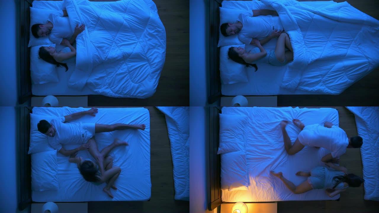 受惊的男人和一个女人躺在床上。晚上时间