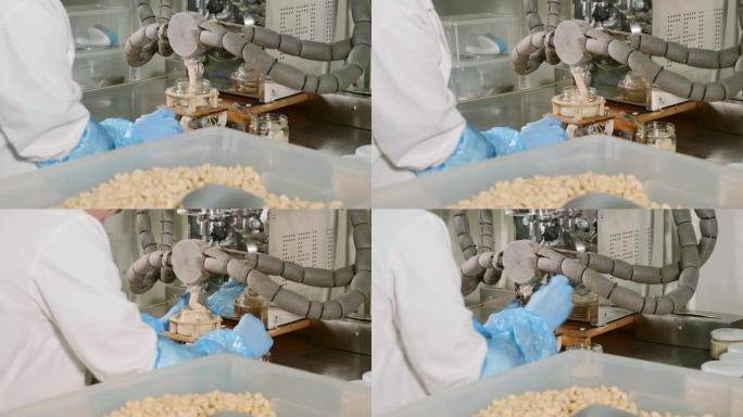 坚果黄油工厂-阶段灌装。坚果奶油放入玻璃罐中，特写镜头