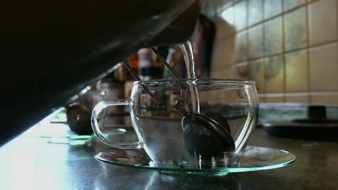 将热水倒入茶杯中。