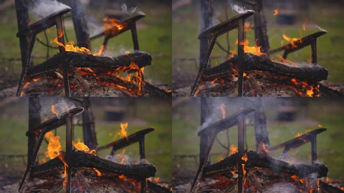 燃烧火并掉落旧的木制扶手椅