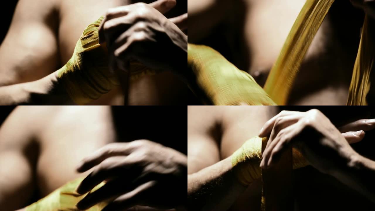 混合武术运动员胶带是用黄色织物制成的手。特写镜头。