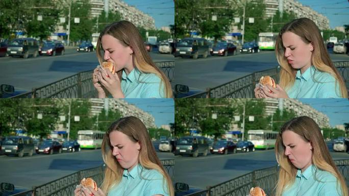 特写镜头一个年轻女孩吃了一个陈旧无味的汉堡包