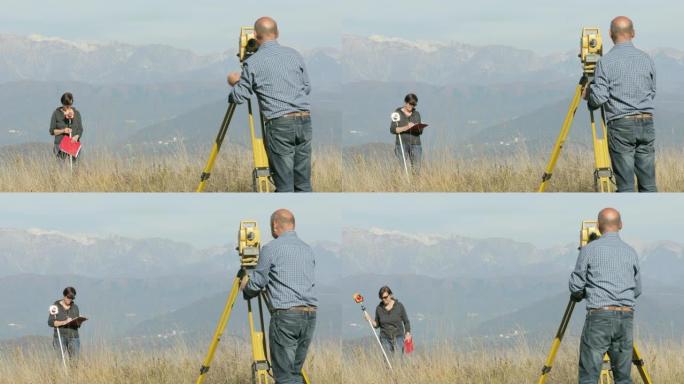 在山顶上工作的测量员