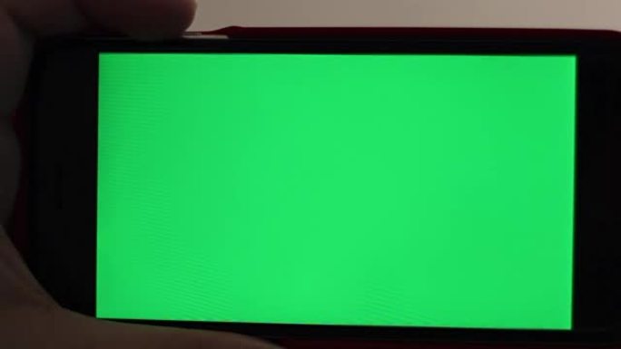 空白绿屏智能手机用手特写