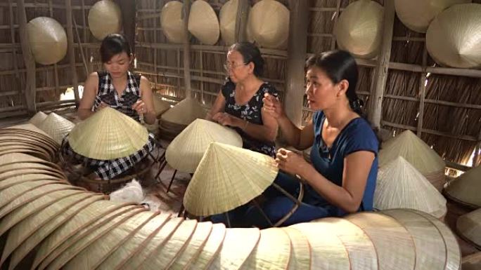 越南坎托省Ap Thoi Phuoc村的一组越南工匠在旧传统房屋中制作传统越南帽子的4k镜头，传统艺