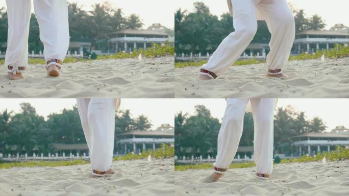 在沙滩上练习太极拳的高级妇女的特写脚