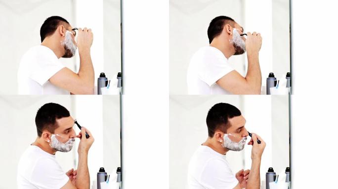 浴室用安全剃刀刮胡子的男人