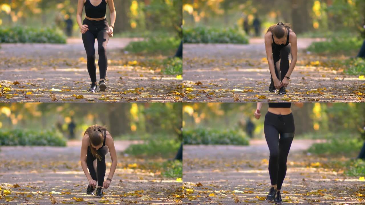 穿着连身裤的女孩的特写肖像，耳机在秋公园里奔跑，停下来系她的士力架，继续慢跑。