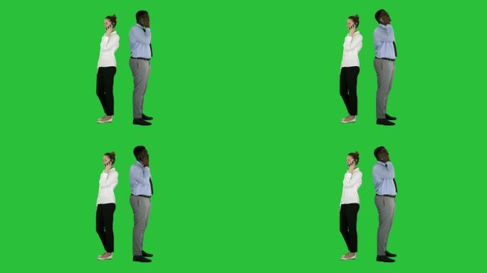 年轻的非洲裔美国男女背靠背站在绿屏上打电话，色键
