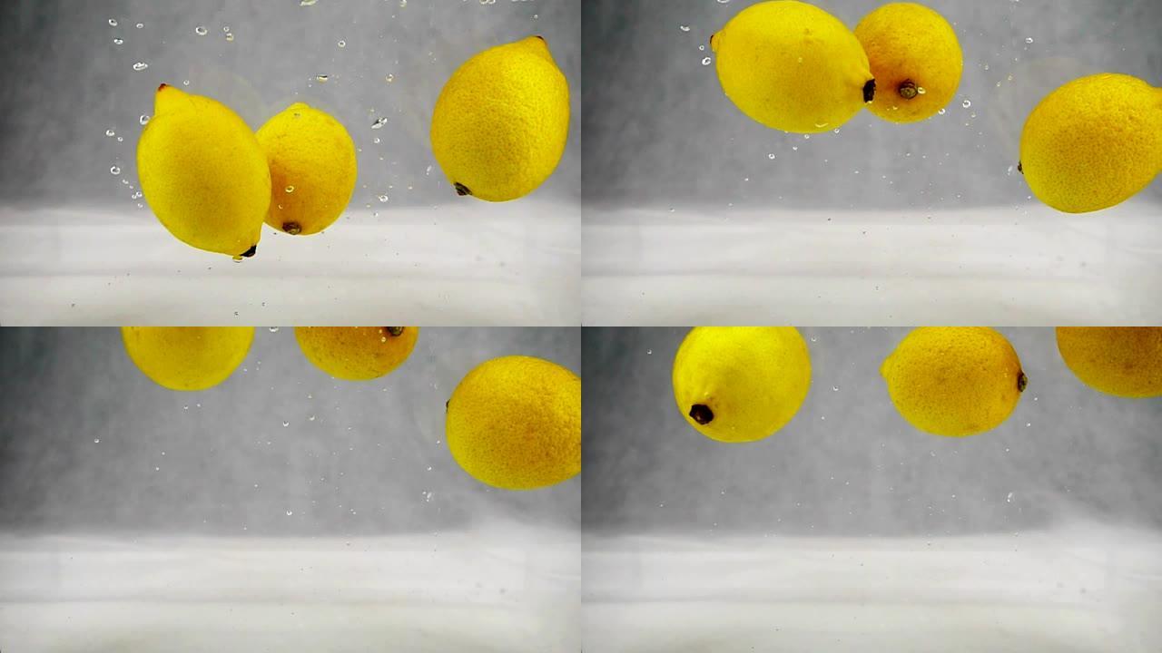 柠檬在水中落下并随着气泡旋转。慢动作水果视频。