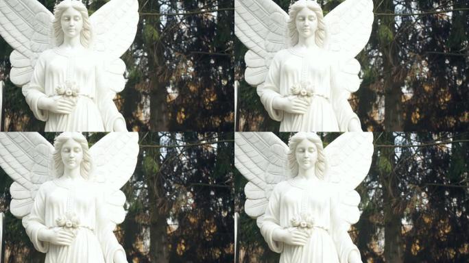 森林背景上的白色天使雕像