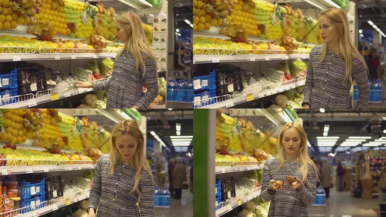 超市里的漂亮女孩在超市里挑选蔬菜和水果。